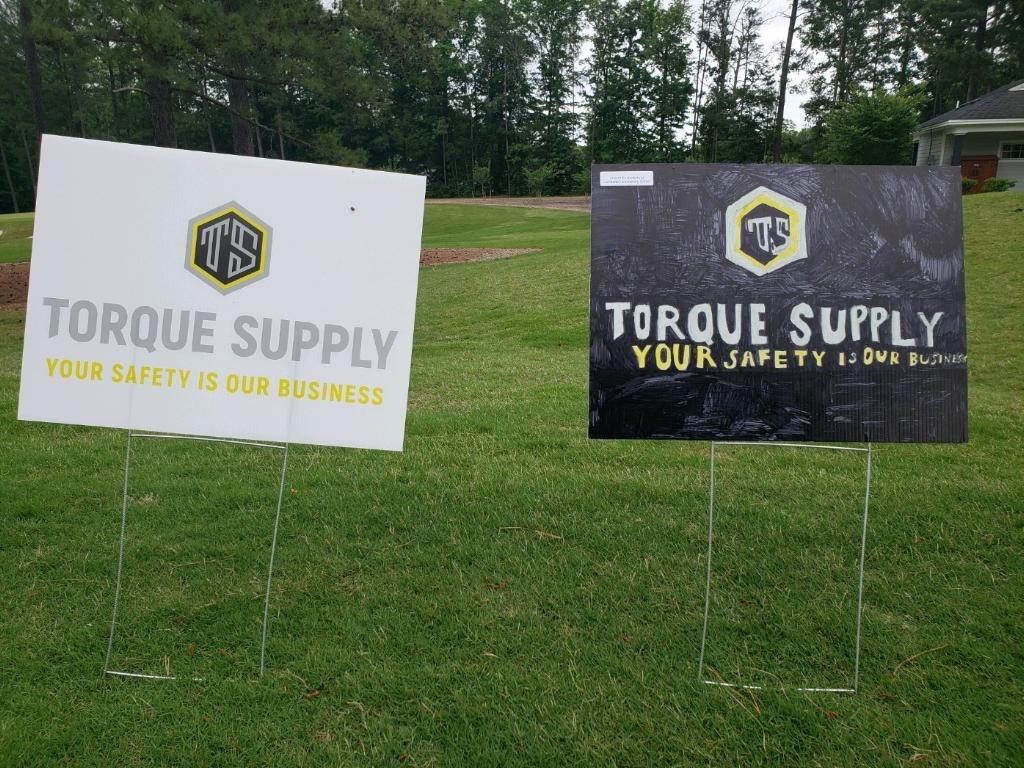 Two sign boards with Torque Supply’s logo